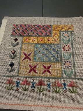 needlepoint project featuring intricate geometric and floral patterns, 🐈‍⬛